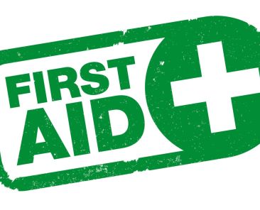 green FIRST AID rubber stamp print with cross symbol