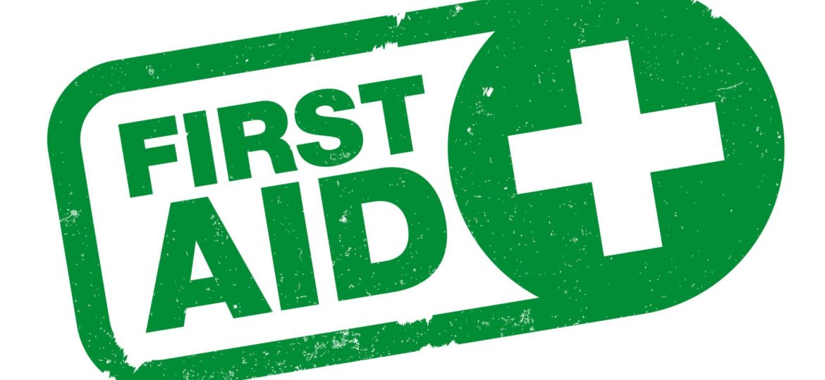 green FIRST AID rubber stamp print with cross symbol